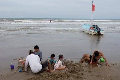 People enjoy the beach as tropical storm Beryl continues to move through the Gulf of Mexico, in Playa Bagdad, Mexico July 6, 2024. REUTERS/Daniel Becerril