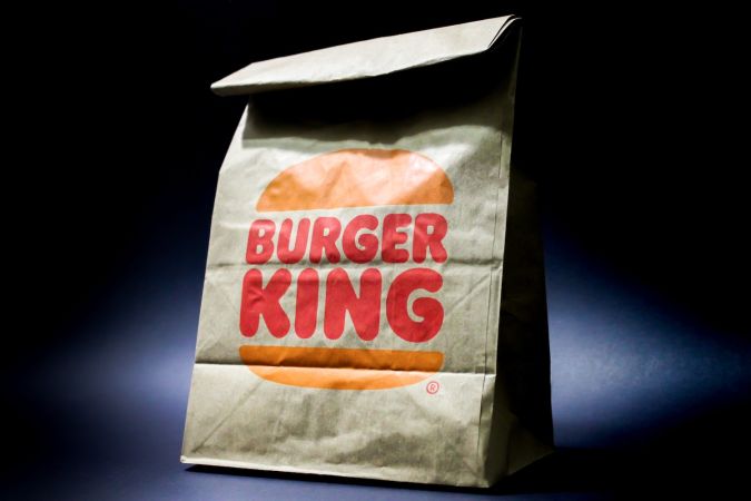 Embalaje de bolsas de papel marrón Burger King sobre fondo negro.